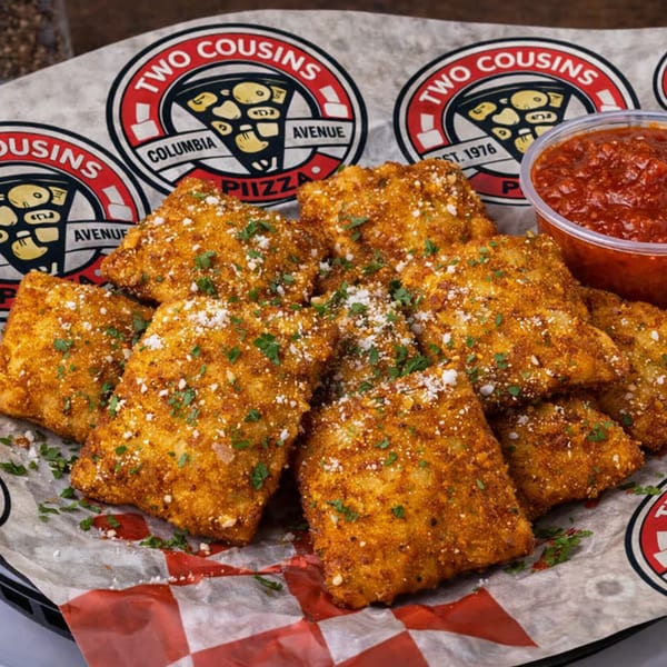 Golden-brown toasted ravioli with parmesan and parsley, served with a side of marinara sauce.